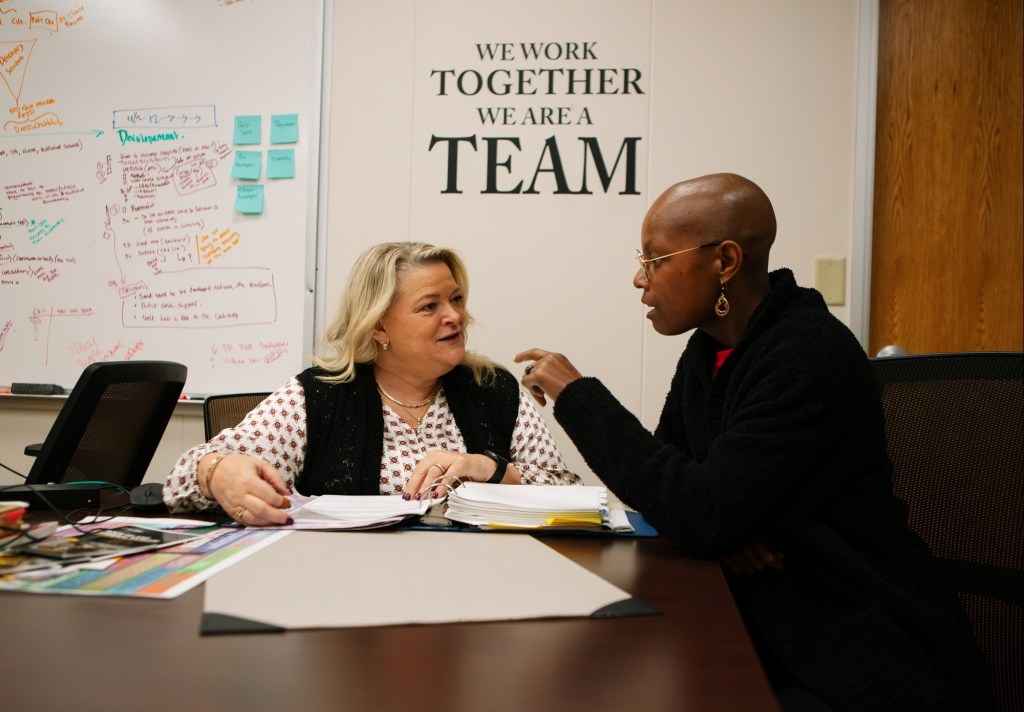 Heidi Massey (left), chief of U.S. Army Sustainment Command’s G6 (Information Management) directorate’s Program Management Division, meets with an employee in her division. The Program Management Division is responsible for ensuring compliance... (Sarah Ridenour)